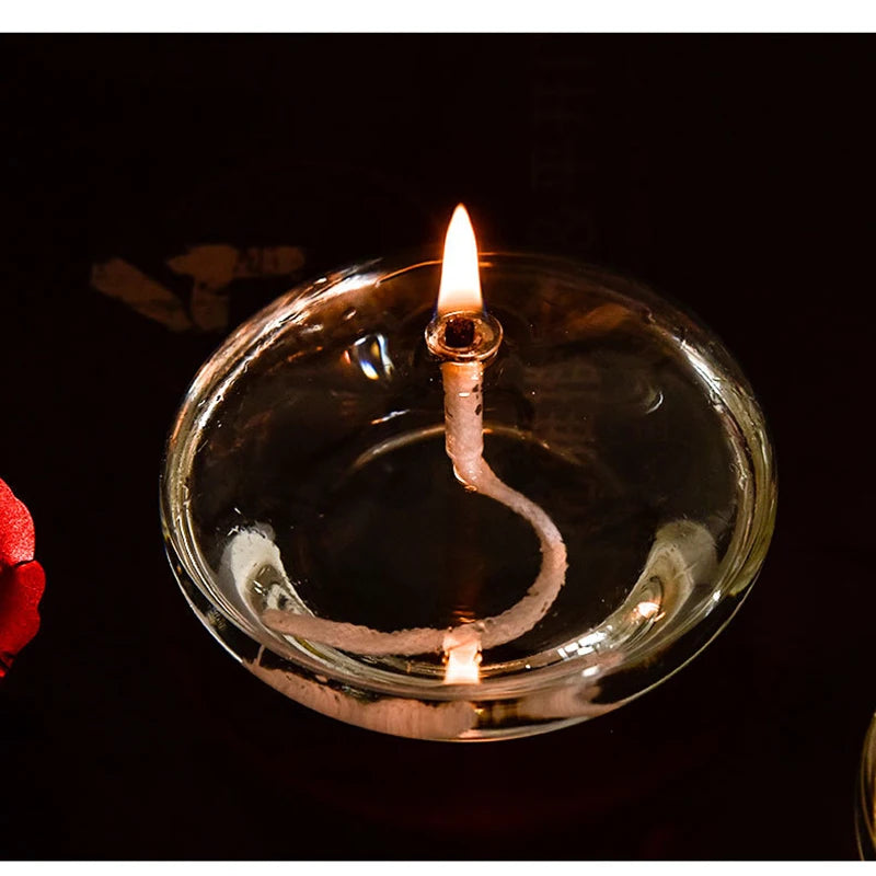 Candle wick in a glass holder with a dark background