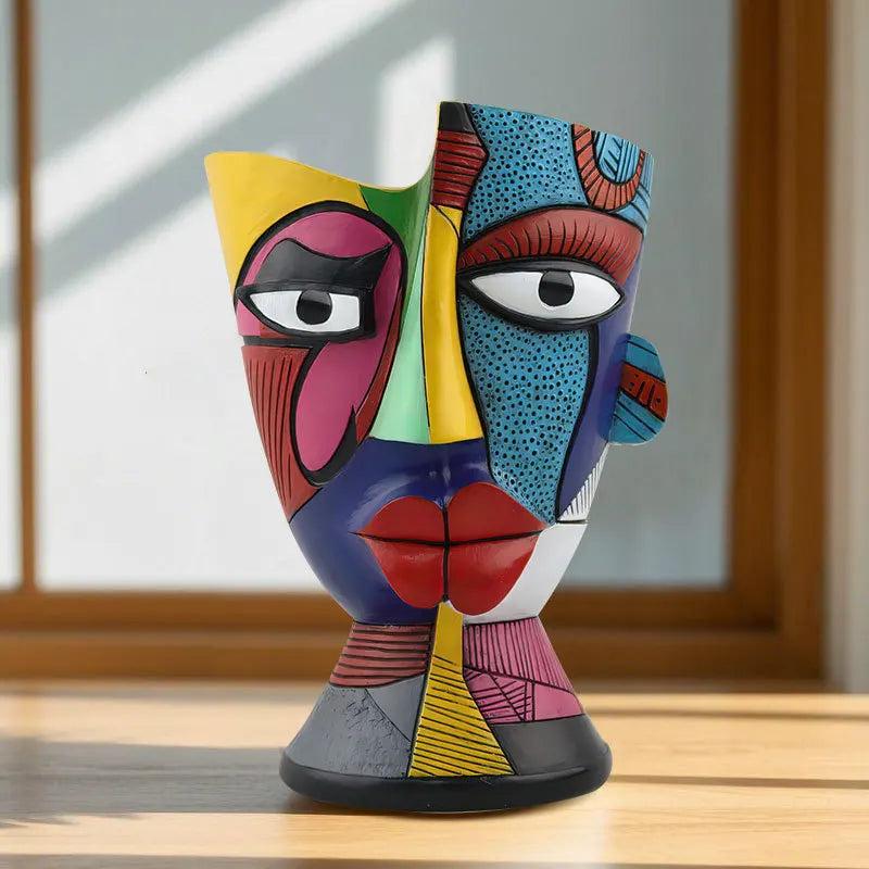 Colorful abstract sculpture on a wooden surface with a window in the background