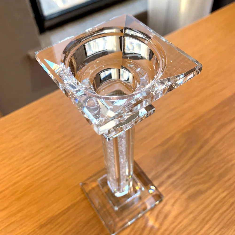 Clear crystal candle holder viewed from the top, on a wooden surface