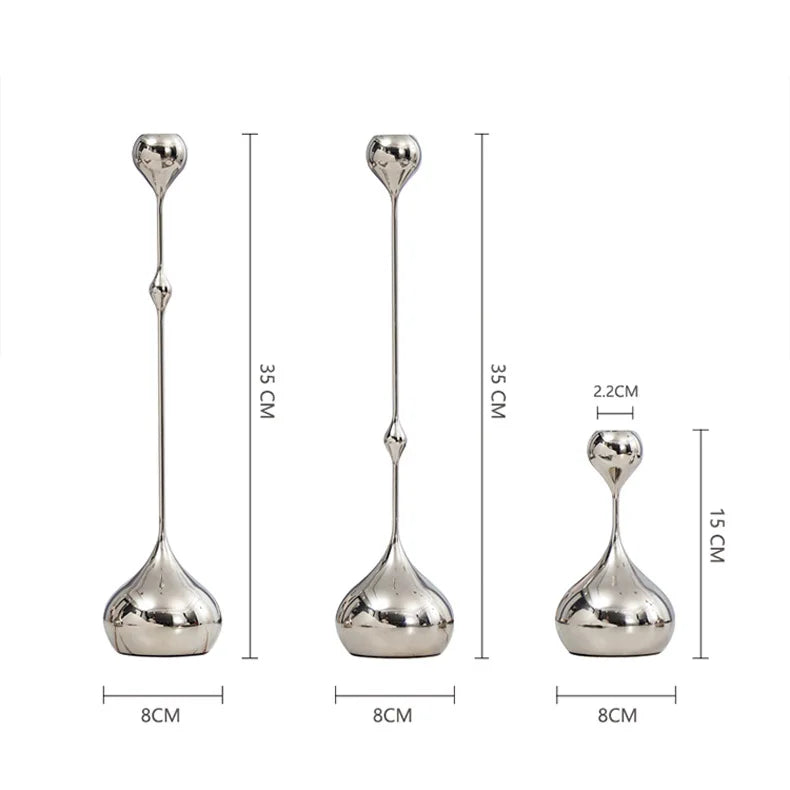 Set of three silver candle holders with measurements on a white background