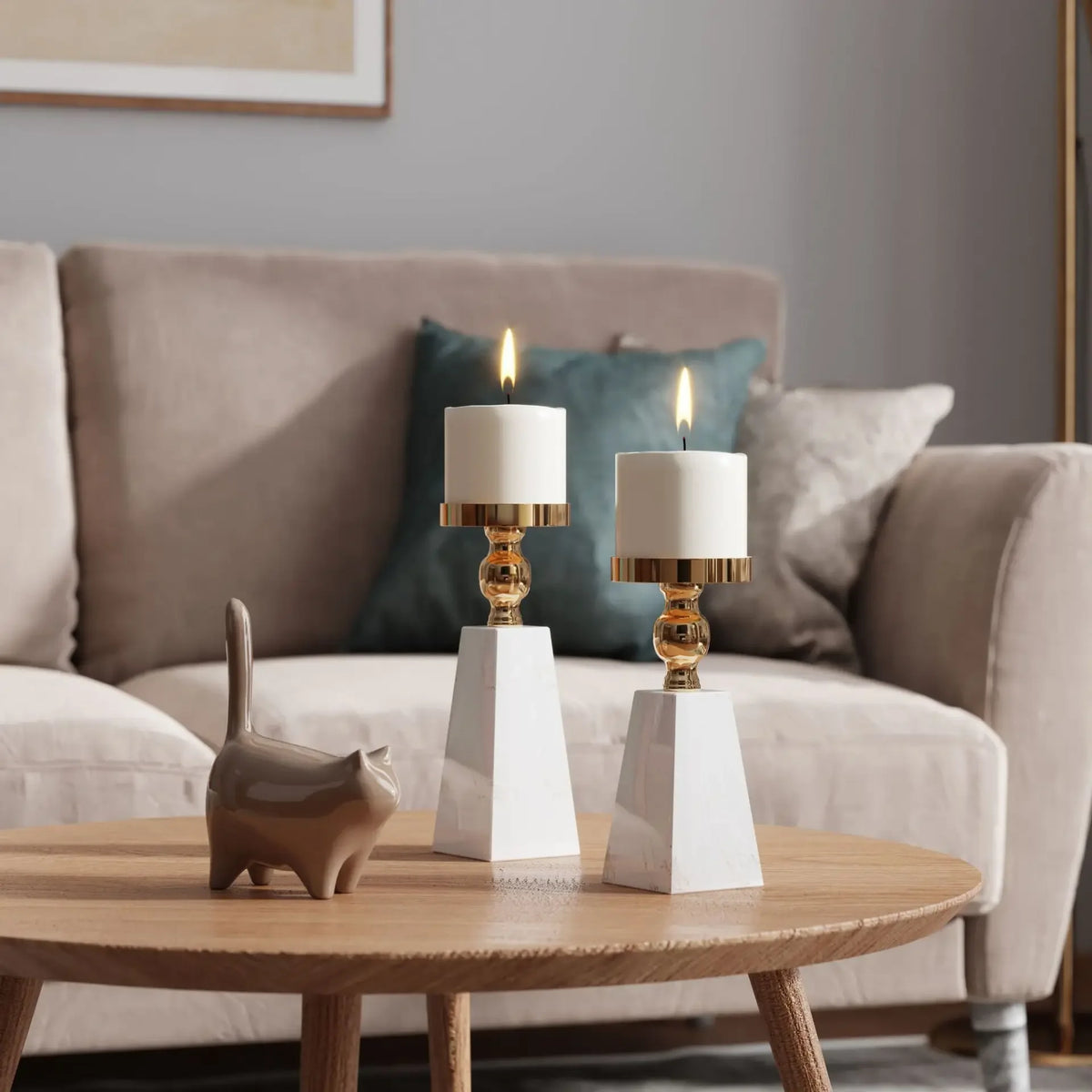 Two white candle holders on a wooden coffee table with a sofa and decorative pillows in the background.