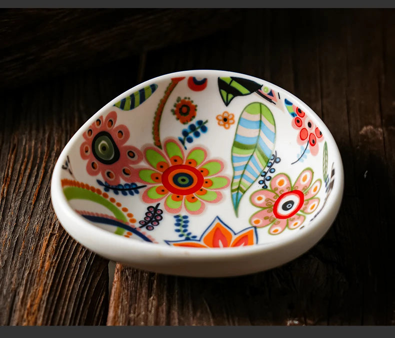 Colorful ceramic dish with floral patterns on a wooden surface