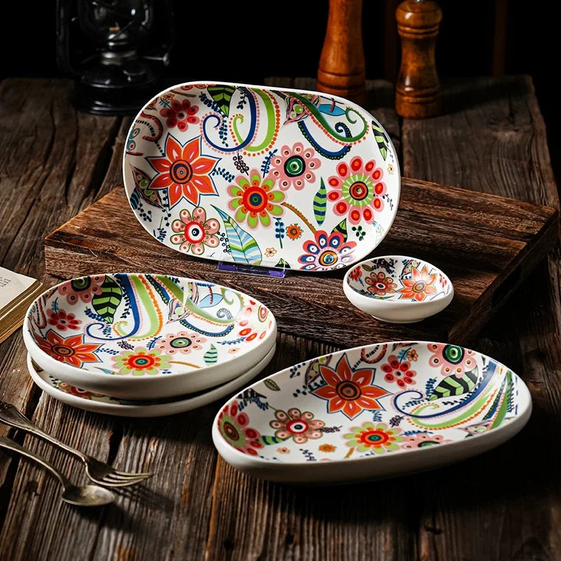 Set of colorful ceramic plates with floral patterns on a wooden surface.