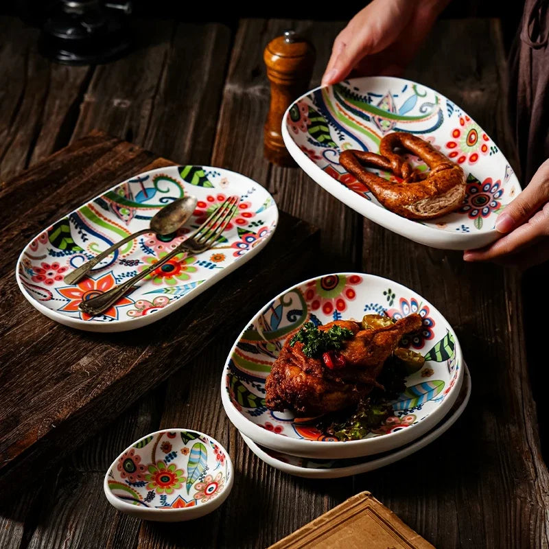 Colorful ceramic plates with floral patterns on a wooden table.