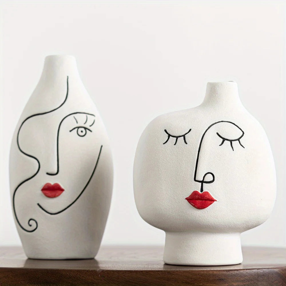 Two ceramic vases with face designs