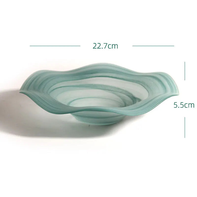 Teal glass bowl with measurements on a white background