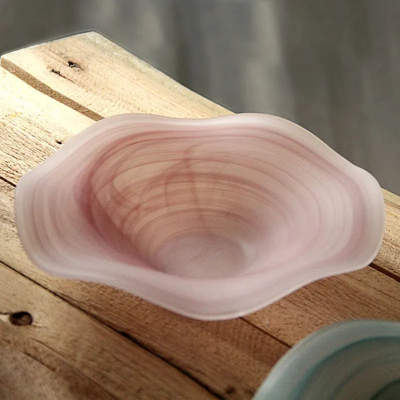 Glass bowl on a wooden surface with a blurred background