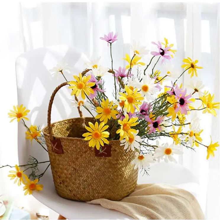 Basket with yellow and pink flowers on a white background