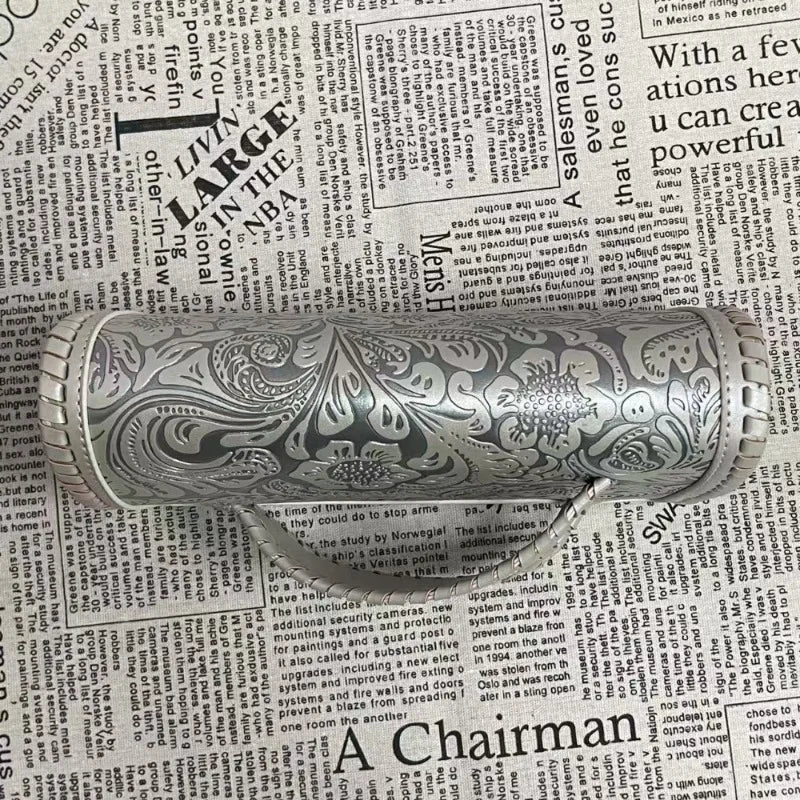 Decorative clutch bag with intricate patterns on a newspaper background