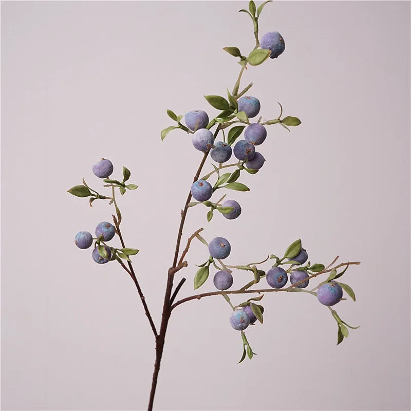 Artificial ffruit branch on a plain background