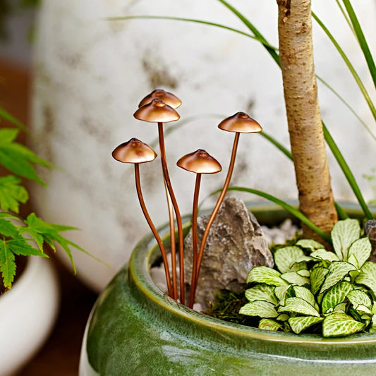 Decorative miniature mushrooms in a pot with plants