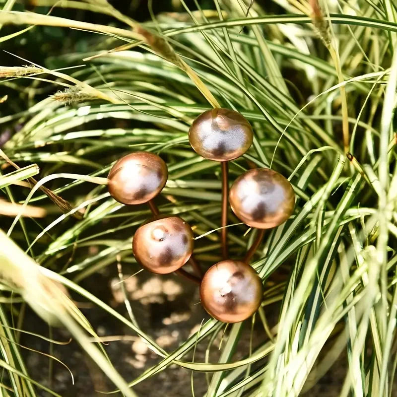 Decorative metal mushrooms on grass