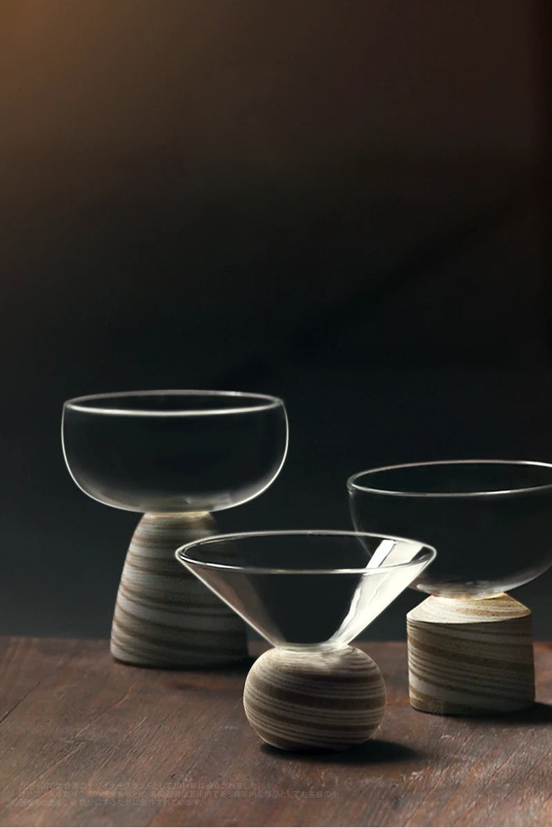 Three glass bowls with clay bases on a dark background