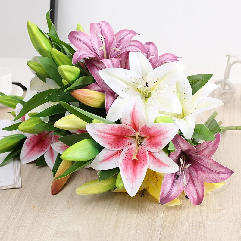 Bouquet of pink, white, and purple lilies on a light wooden surface.