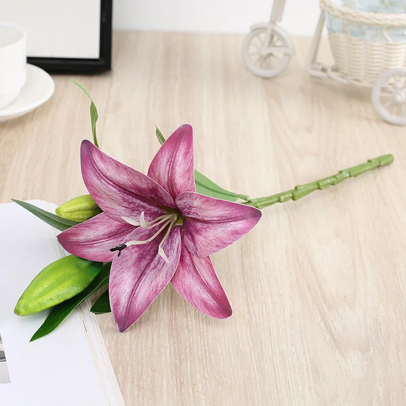 Purple lily flower on a wooden surface with a white cup and saucer in the background