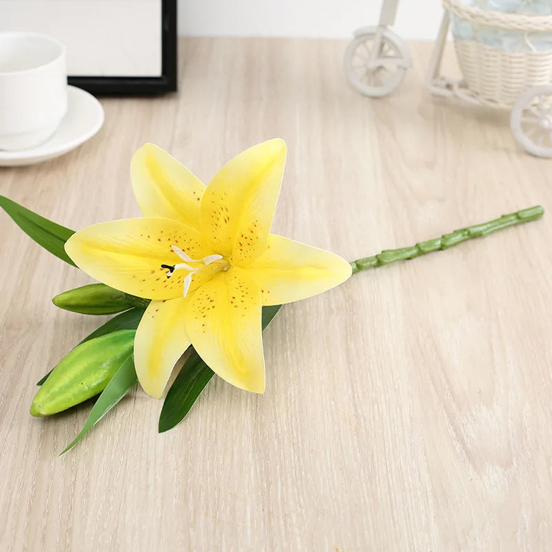 Yellow lily flower on a wooden surface with a blurred background
