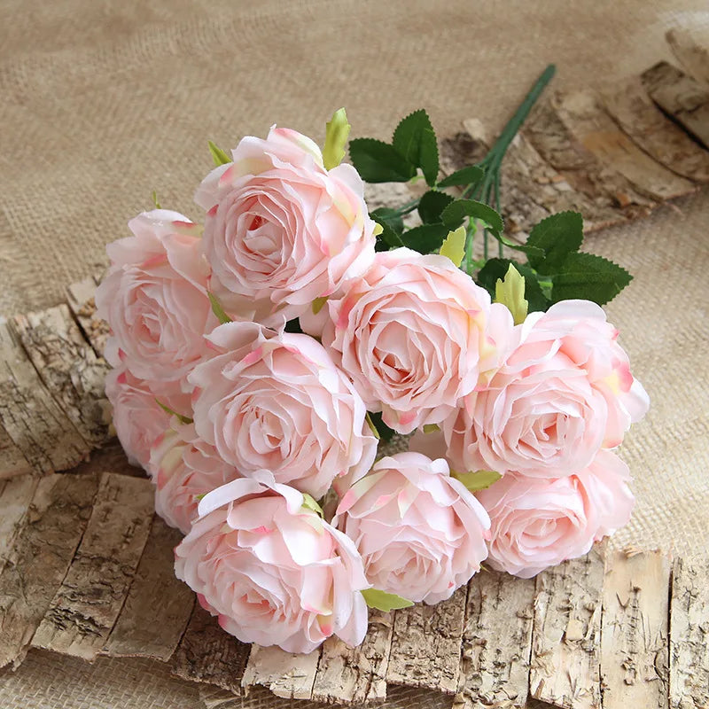 Bouquet of light pink roses on a rustic wooden surface