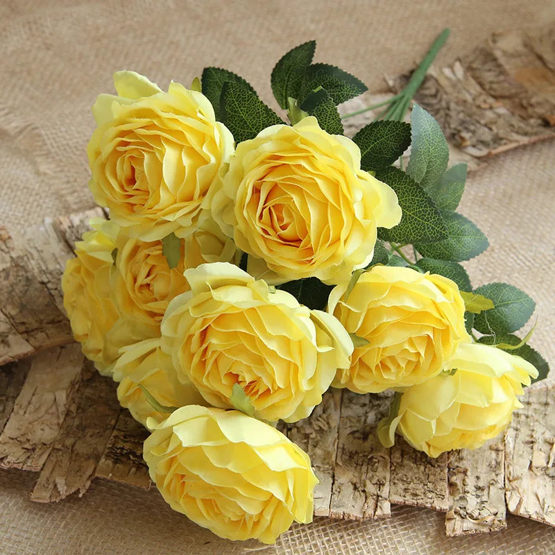 Bouquet of yellow roses on a rustic wooden surface
