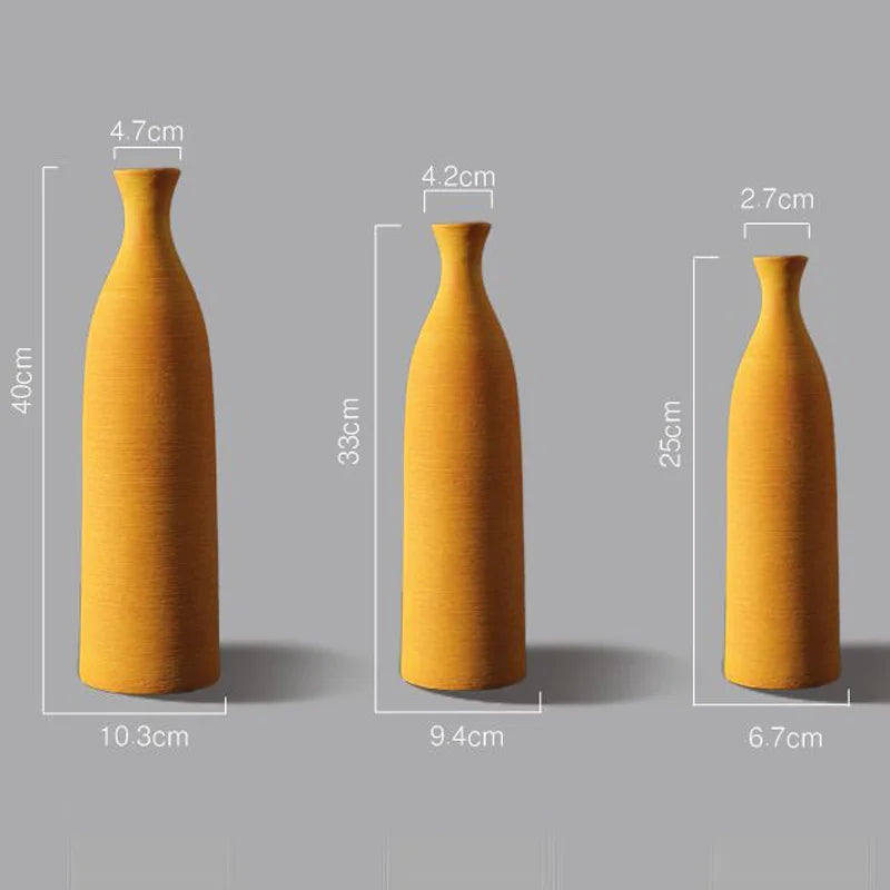 Three mustard yellow vases of different sizes with measurements on a gray background