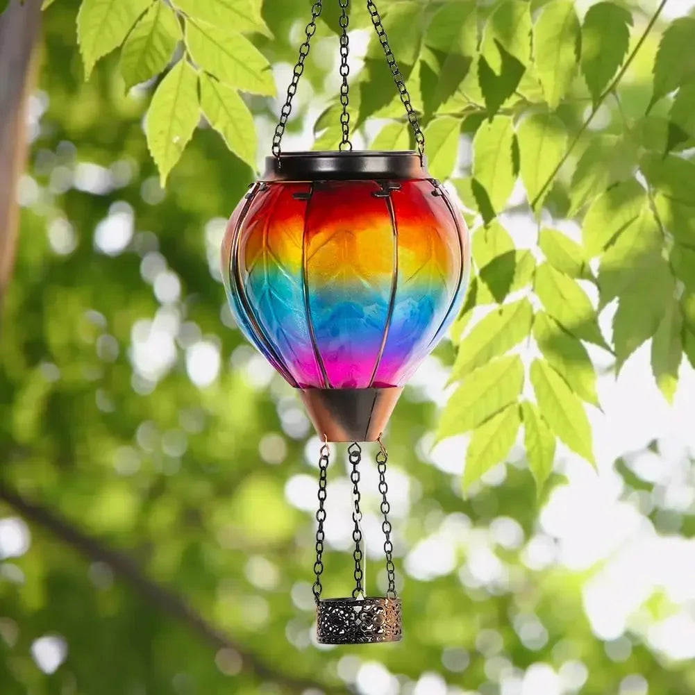 Colorful hanging lantern with leaf design against a green leafy background