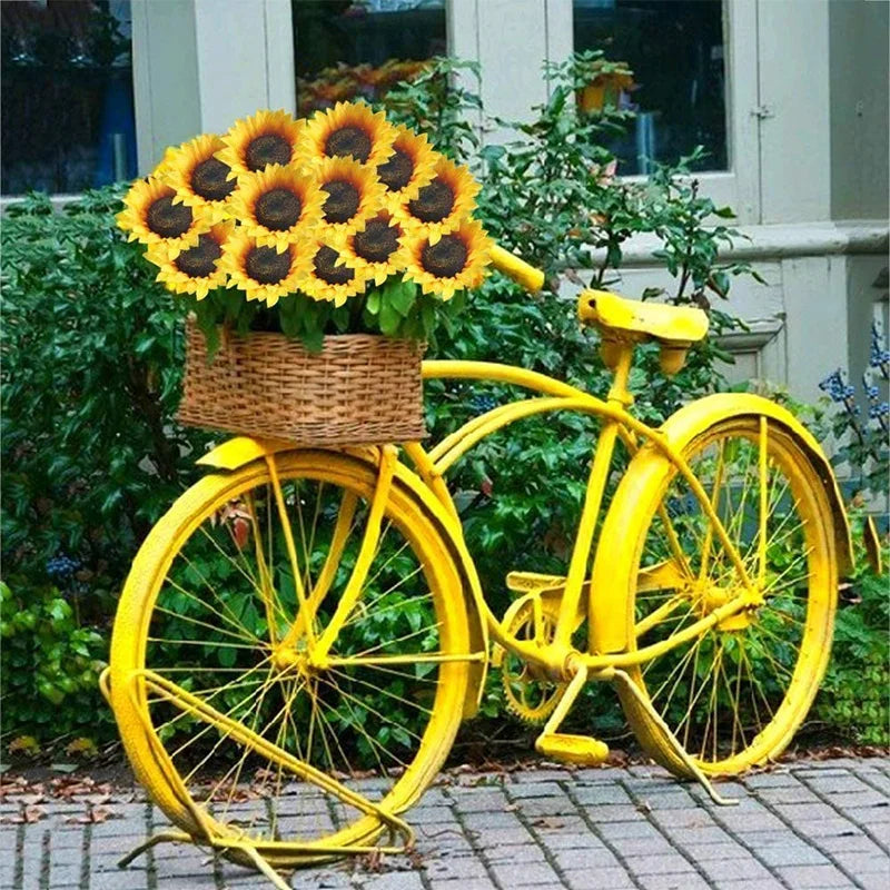 Yellow bicycle with a basket of sunflowers in an outdoor setting