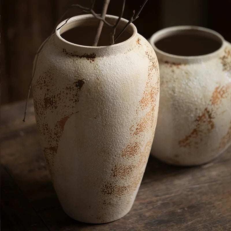 Two rustic ceramic vases on a wooden surface with a dark background