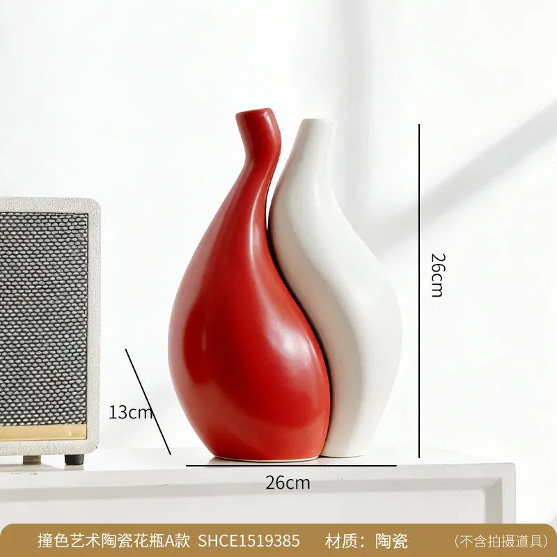 Two ceramic vases, one red and one white, on a white surface with measurements indicated.